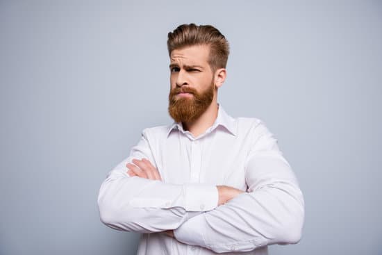 Portrait of serious confident bearded man keeping crossed hands and expressing distrust emotion